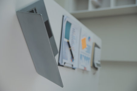 Charming Young asian businesswoman sitting on laptop computer in the office, making report calculating balance Internal Revenue Service checking document.の写真素材