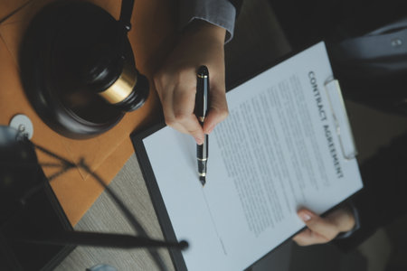 Business and lawyers discussing contract papers with brass scale on desk in office. Law, legal services, advice, justice and law concept picture with film grain effectの写真素材