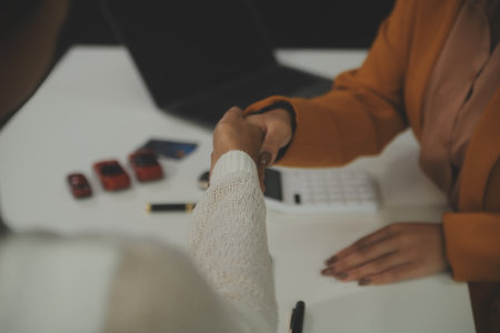 Insurance officers hand over the car keys after the tenant. have signed an auto insurance document or a lease or agreement document Buying or selling a new or used car with a carの写真素材