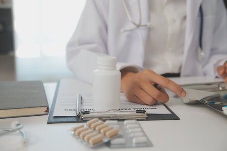 Healthcare service and pharmacy worker with customer at store counter for medication explanation. Pharmaceutical advice and opinion of pharmacist helping girl with medicine information.の写真素材