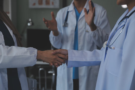 The medical team joins hands and works togetherGroup of scientists joining hands to create experimental works that meet their goals or the success of the trials that have been completedの写真素材