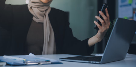 Shot of an attractive mature businesswoman working on laptop in her workstation.の写真素材