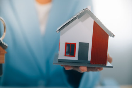 Real estate agent talked about the terms of the home purchase agreement and asked the customer to sign the documents to make the contract legally, Home sales and home insurance concept.の写真素材