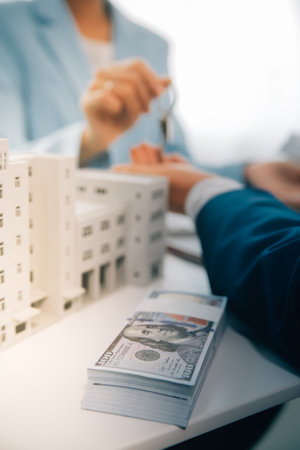 Real estate agent talked about the terms of the home purchase agreement and asked the customer to sign the documents to make the contract legally, Home sales and home insurance concept.の写真素材