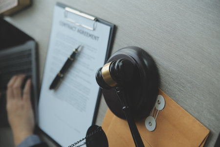 Business and lawyers discussing contract papers with brass scale on desk in office. Law, legal...