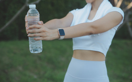 Young woman drinking protein shake outdoorsの写真素材