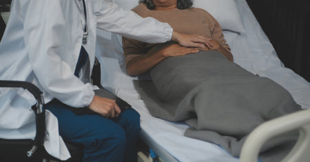 Cropped shot of a female nurse hold her senior patient's hand. Giving Support. Doctor helping old patient with Alzheimer's disease. Female carer holding hands of senior manの写真素材