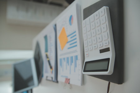 Charming Young asian businesswoman sitting on laptop computer in the office, making report calculating balance Internal Revenue Service checking document.の写真素材