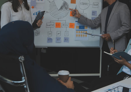 Financial analysts analyze business financial reports on a digital tablet planning investment...