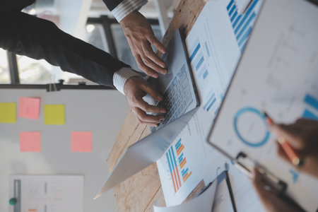 Co working conference, Business team meeting present, investor colleagues discussing new plan financial graph data on office table with laptop and digital tablet, Finance, accounting, investment.の写真素材