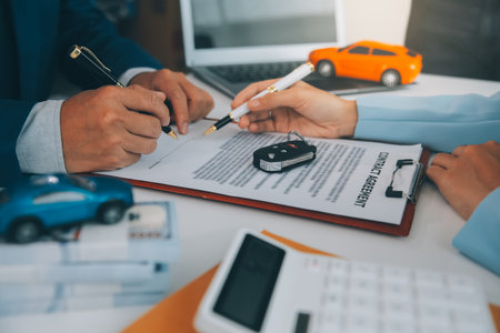 Insurance officers hand over the car keys after the tenant. have signed an auto insurance document or a lease or agreement document Buying or selling a new or used car with a carの写真素材