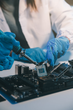 Close up of Technician measuring voltage electronic circuit board television, Service after sale fix electric equipment within insurance.の写真素材