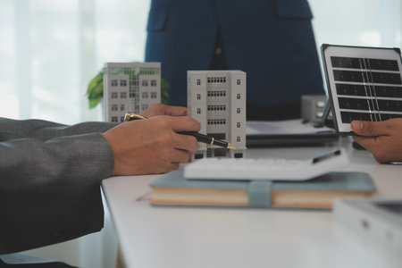 Team of architectures and businessman are discussing and brainstorming on floor plan modification for real estate sustainable investment and solar energy housing development projectの写真素材
