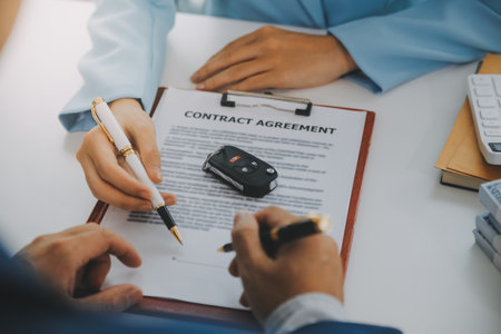 Insurance officers hand over the car keys after the tenant. have signed an auto insurance document or a lease or agreement document Buying or selling a new or used car with a carの写真素材