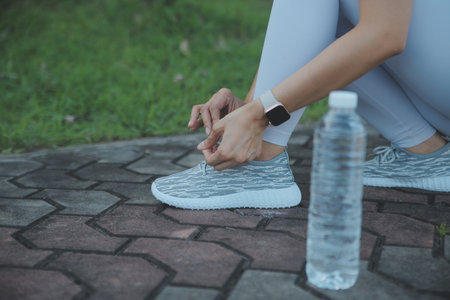 Young woman drinking protein shake outdoorsの写真素材