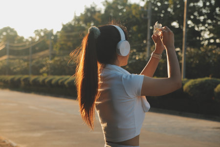 Young fitness woman runner stretching legs before run on cityの写真素材