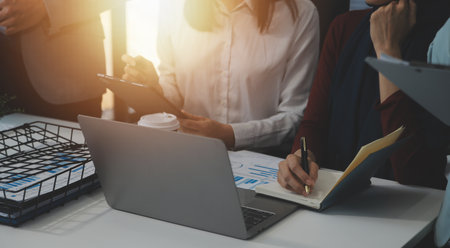 Financial analysts analyze business financial reports on a digital tablet planning investment...