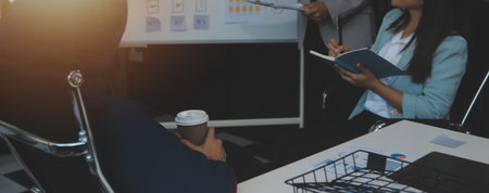 Financial analysts analyze business financial reports on a digital tablet planning investment...