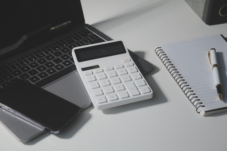Office leather desk table with calculator and pen. Top view with copy spaceの写真素材