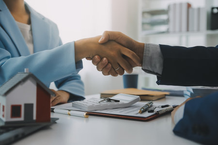 Real estate agent talked about the terms of the home purchase agreement and asked the customer to sign the documents to make the contract legally, Home sales and home insurance concept.の写真素材
