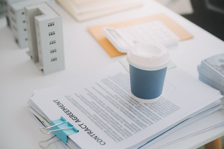 Real estate agent talked about the terms of the home purchase agreement and asked the customer to sign the documents to make the contract legally, Home sales and home insurance concept.の写真素材