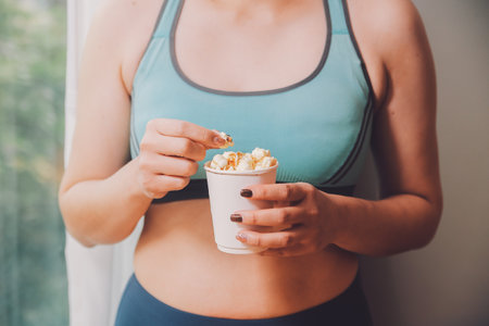 A woman holding a bowl of popcornの写真素材