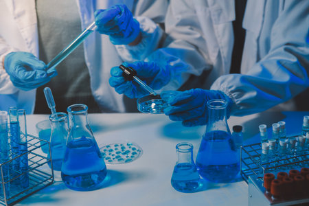 chemist,scientist hand dropping chemical liquid into test tube, science research and development conceptの写真素材