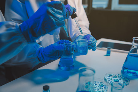 chemist,scientist hand dropping chemical liquid into test tube, science research and development conceptの写真素材