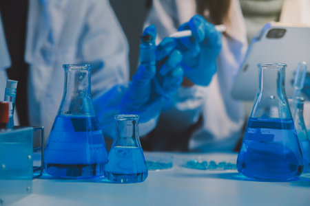 chemist,scientist hand dropping chemical liquid into test tube, science research and development conceptの写真素材