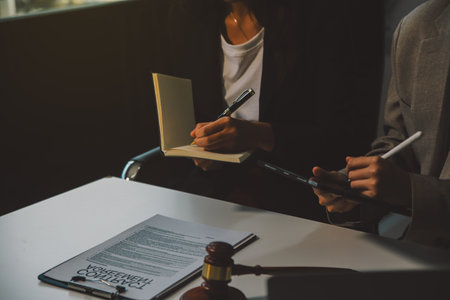 Lawyer, legal advisor, businessman brainstorming information on agreement details Business contracts in legal processing books for accuracy in contract documents. joint financial investment.の写真素材