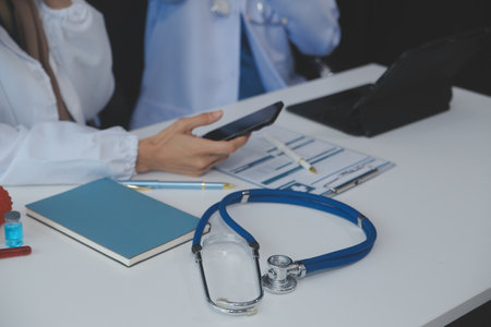 Doctor discussing diagnosis during the meeting. Group of doctor discussing work matter in the office at work. The medical team discusses treatment options with the patient.の写真素材