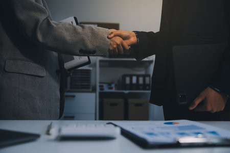 Business handshake for teamwork of business merger and acquisition,successful negotiate,hand shake,two businessman shake hand with partner to celebration partnership and business deal conceptの写真素材