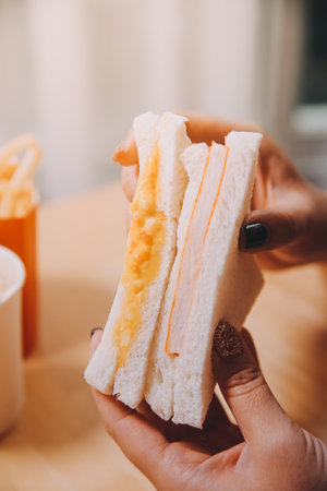 Asian healthy woman have breakfast with sandwich in morningの写真素材