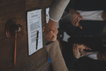 Judge gavel with Justice lawyers having team meeting at law firm background. Concepts of Law and Legal services.の写真素材