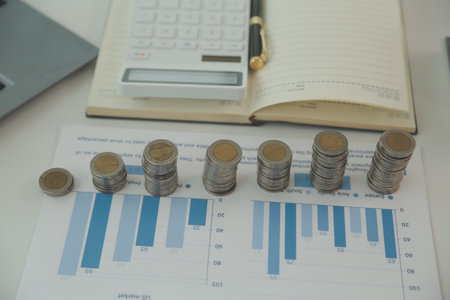 Saving money wealth concept, asian young business woman hand write management budget for saving cost, cash finance planning to spend enough money on her income for save money, payment tax, investing.の写真素材