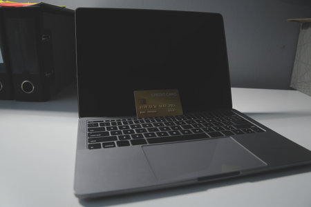 Calculator on a dark background, plastic cards and banknotes