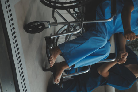 Doctor giving hope. Close up shot of young female physician leaning forward to smiling elderly lady patient holding her hand in palms. Woman caretaker in white coat supporting encouraging old personの写真素材