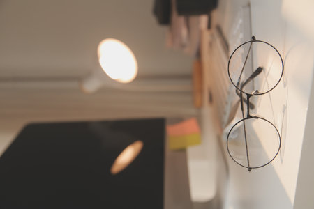 Desk with laptop, eye glasses, earphone, pen and a cup of coffee. Top view with copy space.