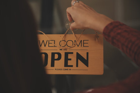 Startup successful small business owner sme beauty girl stand with tablet smartphone in coffee shop restaurant. Portrait of asian tan woman barista cafe owner. SME entrepreneur seller business conceptの写真素材
