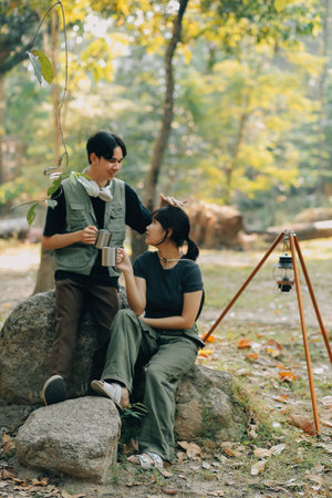 Asian couple sweet in tent inside on they camping trip, traveller relax and sleep togather in out door and camping tripの写真素材