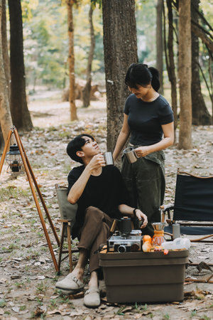 Asian couple sweet in tent inside on they camping trip, traveller relax and sleep togather in out door and camping tripの写真素材