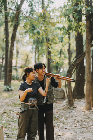 Asian couple sweet in tent inside on they camping trip, traveller relax and sleep togather in out...