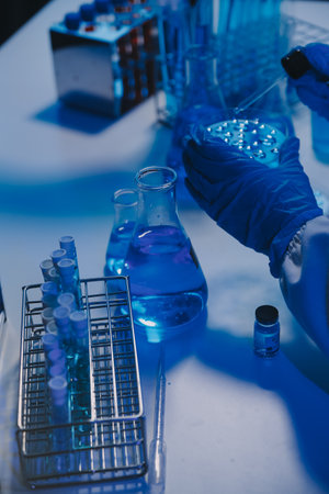 chemist,scientist hand dropping chemical liquid into test tube, science research and development conceptの写真素材