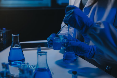 chemist,scientist hand dropping chemical liquid into test tube, science research and development...