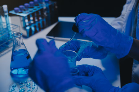 chemist,scientist hand dropping chemical liquid into test tube, science research and development...