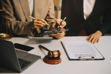 Lawyer, legal advisor, businessman brainstorming information on agreement details Business contracts in legal processing books for accuracy in contract documents. joint financial investment.の写真素材