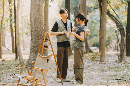 Asian couple sweet in tent inside on they camping trip, traveller relax and sleep togather in out door and camping tripの写真素材