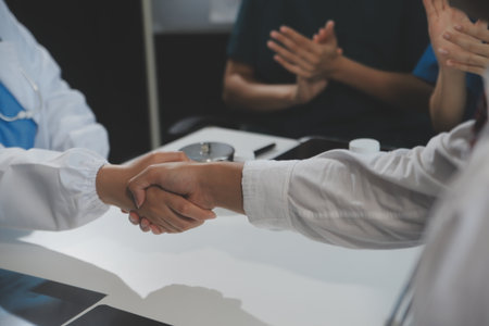 Doctor handshake and partnership in healthcare, medicine or trust for collaboration, unity or support.Team of medical experts shaking hands in teamwork for or success in hospitalの写真素材