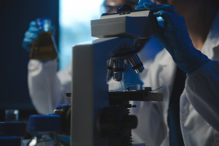 professional chemist woman laboratory using scientific microscope for science research, chemistry...