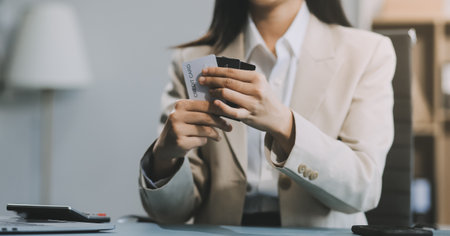 Asian woman holding credit card and using laptop computer for shopping online in website at home, e-commerce, internet banking, Technology and money transfer. Shopping and online payment concept.の写真素材